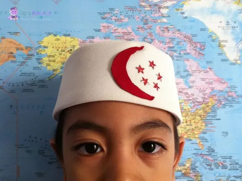 Syauqi in a white kopiah with the red crescent and five stars of the Singapore flag