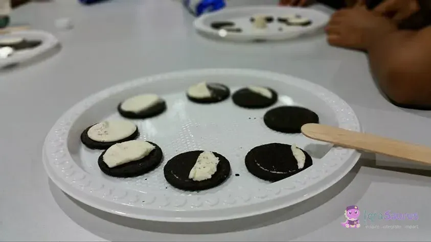 Sandwich biscuits on a plate with the cream scraped away to show the phases of the moon